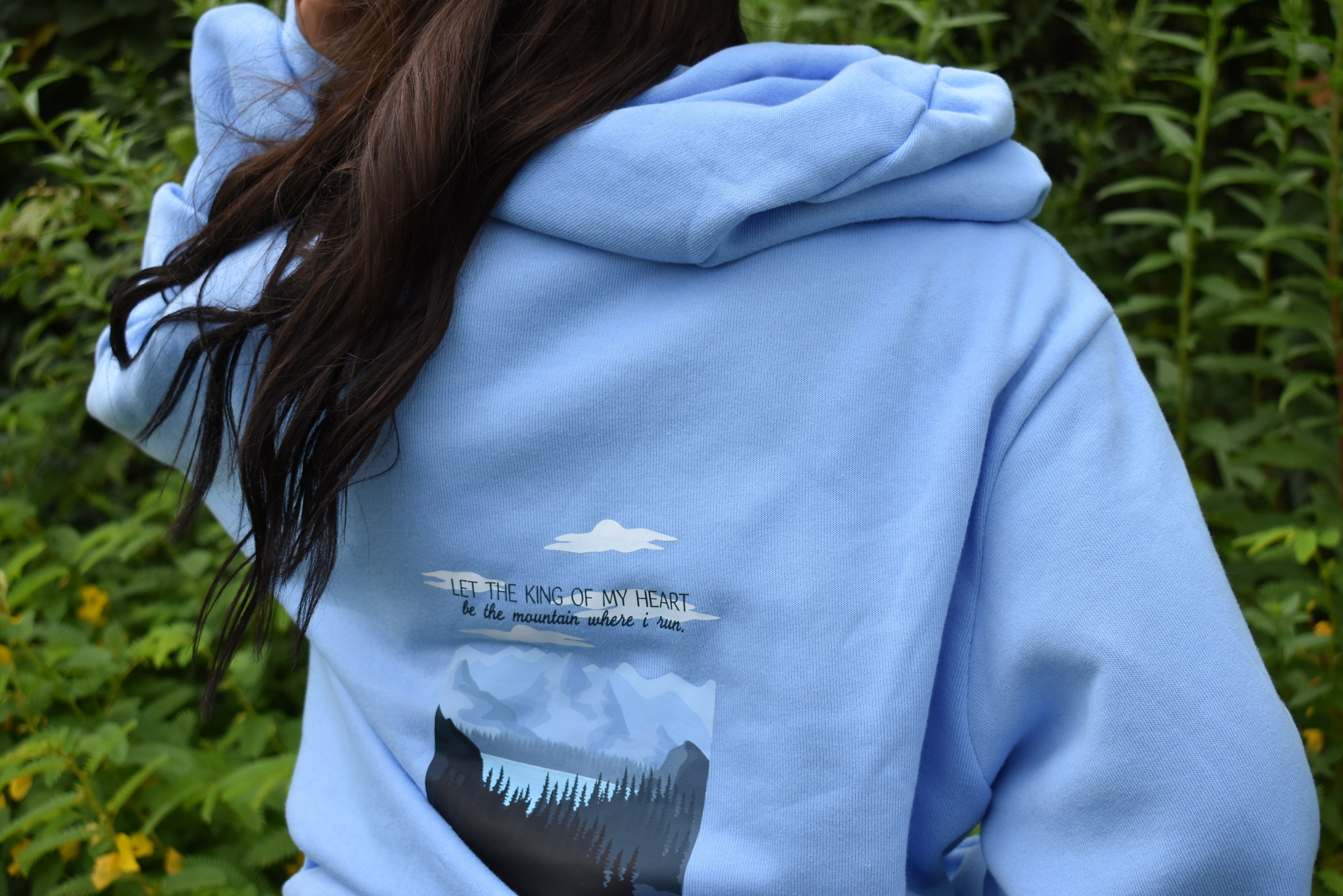 Woman wearing Faithfully Yours hoodie outdoors